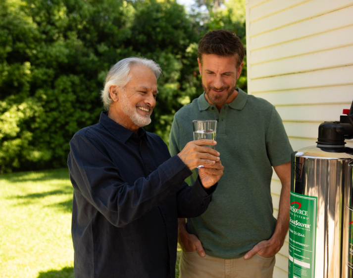 Family looking at a glass of clear water
